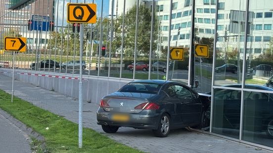 Auto ramt glazen gevel stadskantoor, risico dat glasplaat eruit valt